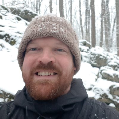 Picture of the Owner, Kyle Berwick, in the woods in winter